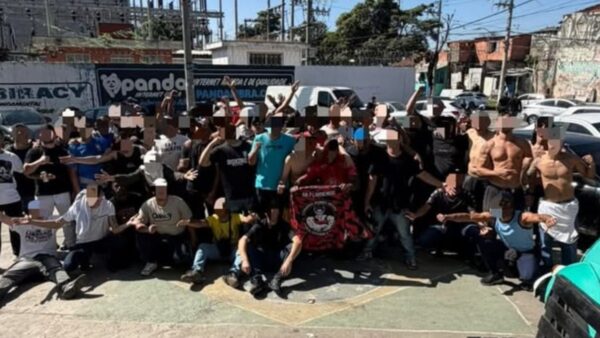 Integrantes de torcida organizada posam para foto com rostos borrados