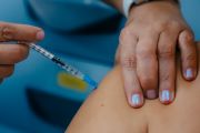 Profissional de saúde aplica vacina contra o sarampo no braço de um paciente