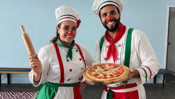 Dupla fantasiada de cozinheiros italianos segura pizza durante divulgação da Festa Italiana de São Caetano